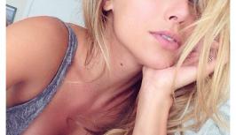 Sexy blonde girl is lying in the bed