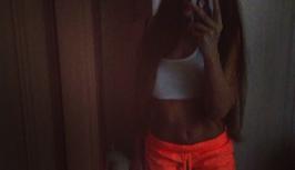 Beautiful girl in bright orange shorts on chat